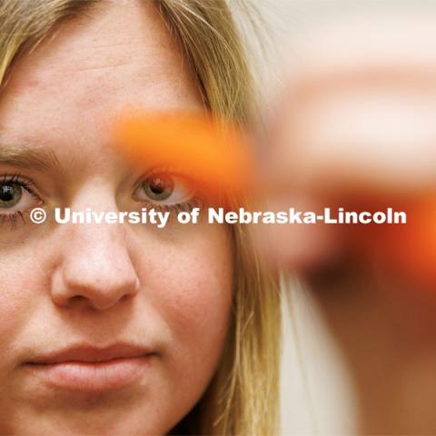 Dr. Kate Higgins, an Athletic Neuropsychologist with Husker Athletics, performs a Vestibular Ocular Motor Screening (VOMS) test on mock patient Makayla Burchett, a freshman from Harlan, Iowa in the new concussion clinic. Burchett follows a pen around a pattern drawn by Higgins. The University Health Center and Nebraska Medicine recently moved its concussion clinic to the Nebraska Performance Lab in the east stadium space. February 1, 2023. Photo by Craig Chandler / University Communication.