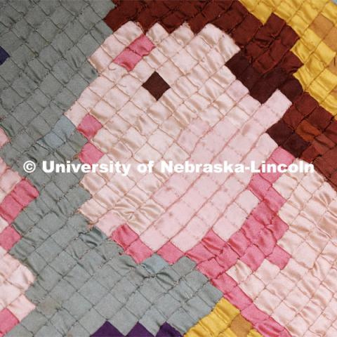 A closeup of  the Ruth and Naomi Quilt sewn by Charles Pratt in the 1930s. The quilt is comprised of 1/4 inch squares of fabric. Quilt Center. February 8, 2023. Photo by Craig Chandler / University Communication.