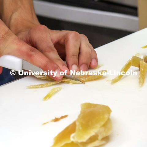 A cricket centerpiece is prepared as part of the team's entry. Groups prepared baked goods using flour made from crickets. Battle of the Food Scientists at Nebraska Innovation Campus. February 15, 2023. Photo by Blaney Dreifurst / University Communication.