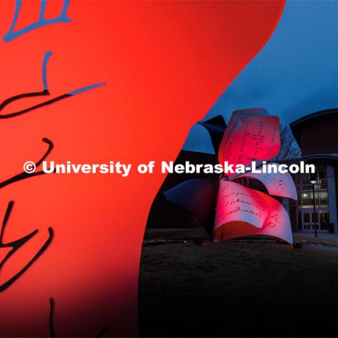Close up of the Torn Notebook sculpture lit up red for Glow Big Red. February 15, 2023. Photo by Craig Chandler / University Communication.