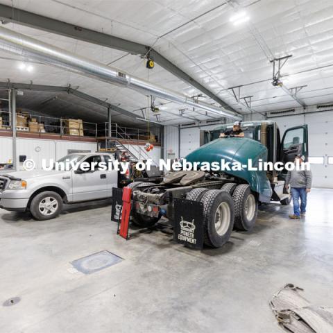 Jeff Hornung talks with employee Kelton Walz in the shop as Walz works to recondition a 2019 Kenworth for resale. Hornung and his Pioneer Equipment business in Hastings, Nebraska. Hornung is a former Engler student and has grown his business selling used large trucks world wide. February 21, 2023. Photo by Craig Chandler / University Communication.