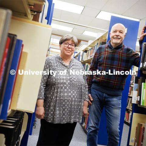 Joanie Barnes (left) and Tom McFarland stand in the stacks of Love Library. The duo founded the Genealogy over Lunch group. February 27, 2023. Photo by Craig Chandler / University Communication.