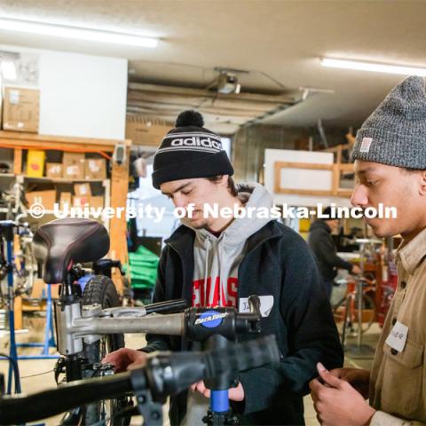 Engineering student Jacob Dalton and Connor Herbert work on repairing a bike in Lincoln Bike Kitchen Repair. The Bike Kitchen is among a number of local organizations that the College of Engineering works with to offer service learning opportunities to its students. March 9, 2023. Photo by Dillon Galloway for University Communication.