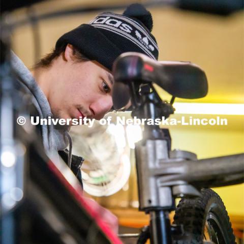 Engineering student Jacob Dalton works on repairing a bike in Lincoln Bike Kitchen Repair. The Bike Kitchen is among a number of local organizations that the College of Engineering works with to offer service learning opportunities to its students. March 9, 2023. Photo by Dillon Galloway for University Communication.