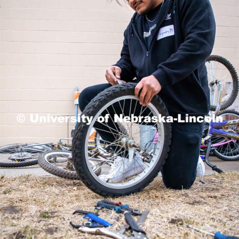 Engineering student Alejandro Marquez works on repairing a bike at Lincoln Bike Kitchen Repair. The Bike Kitchen is among a number of local organizations that the College of Engineering works with to offer service learning opportunities to its students. March 9, 2023. Photo by Dillon Galloway for University Communication.