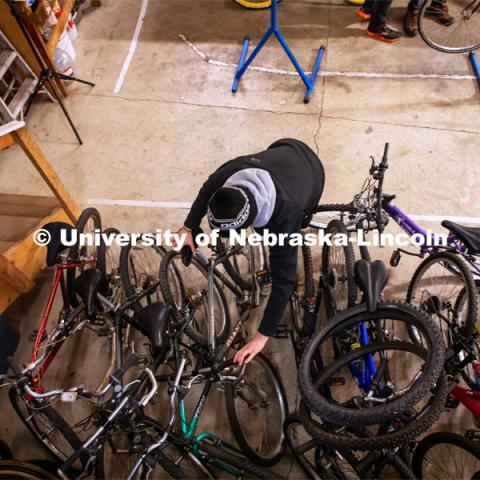 Engineering student Jacob Dalton works on repairing a bike at Lincoln Bike Kitchen Repair. The Bike Kitchen is among a number of local organizations that the College of Engineering works with to offer service learning opportunities to its students. March 9, 2023. Photo by Dillon Galloway for University Communication.