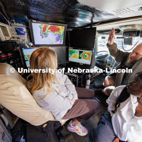 Josh Aikins of the University of Illinois’ Flexible Array of Radars and Mesonets, explains the workings of the radar truck to Husker sophomore Hope Cumming (left), and junior Jacquie Paul (bottom). The Doppler on Wheels, part of the Flexible Array of Radars and Mesonets operated by the University of Illinois, is on campus this week so Adam Houston’s TORUS team can train with it. The DOW is also being demonstrated to the meteorology students. March 20, 2023. Photo by Craig Chandler / University Communication.