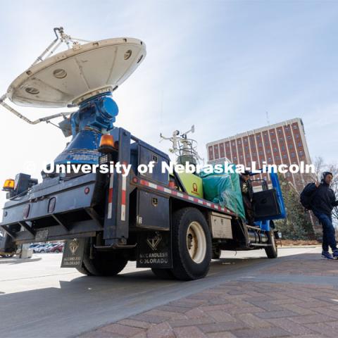 Students hop out of The Doppler on Wheels, part of the Flexible Array of Radars and Mesonets operated by the University of Illinois. The radar truck is on campus this week so Adam Houston’s TORUS team can train with it. The DOW is also being demonstrated to the meteorology students. March 20, 2023. Photo by Craig Chandler / University Communication.