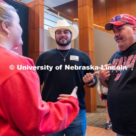 University of Nebraska student representatives speak with out-of-state students and their families during student admission’s National Tailgate at the Wick Alumni Center on Friday, March 24, 2023. 
 Photo by Jordan Opp for University Communication.