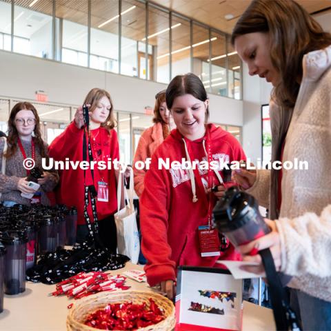 New students grab water bottles and stickers during Admitted Student Day inside Carolyn Pope Edwards Hall. Admitted Student Day is UNL’s in-person, on-campus event for all admitted students. March 24, 2023. Photo by Jordan Opp for University Communication.