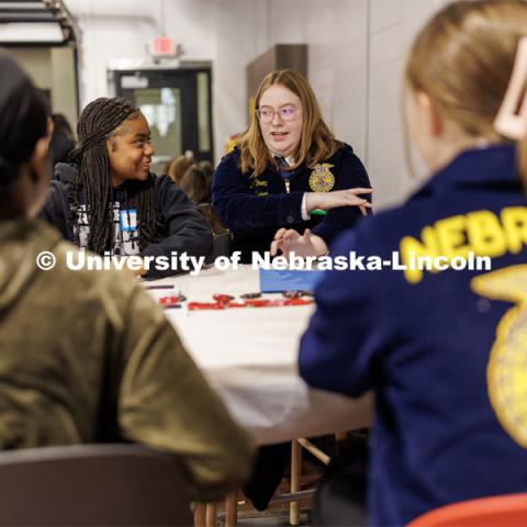 Breelyn Willmott of Blair, right, share a story with Geniah Story of Lincoln Northeast. FFA pen pals from urban and rural schools meet face-to-face during the FFA state convention. March 29, 2023. Photo by Craig Chandler / University Communication.