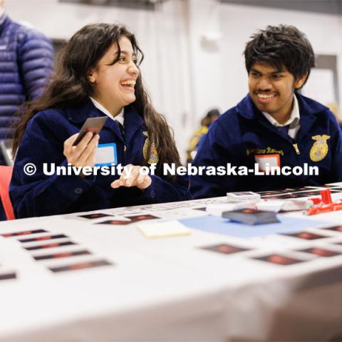 Fatima Pavila and Maximiliano from Omaha Bryant High School react as they play a card game with others. FFA pen pals from urban and rural schools meet face-to-face during the FFA state convention. March 29, 2023. Photo by Craig Chandler / University Communication.