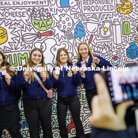 FFA members from Tekamah-Herman are photographed by their advisor in front of the Dairy Story mural. FFA pen pals from urban and rural schools meet face-to-face during the FFA state convention. March 29, 2023. Photo by Craig Chandler / University Communication.