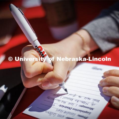 Students signed cards addressed to their state senator about why they love the university. I love UNL cookout sponsored by ASUN. April 4, 2023. Photo by Craig Chandler / University Communication.