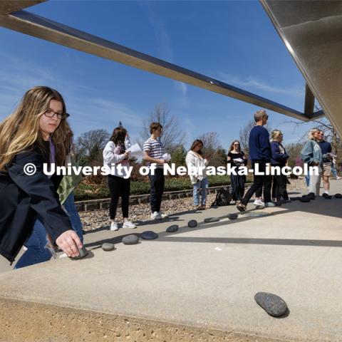 Annalyse Gallo, a sophomore from Chicago, places a rock on the Holocaust Memorial. In Jewish cemeteries, the tradition is to place rocks on the grave rather than flowers.
History of the Holocaust course students visit the Holocaust memorial in Lincoln’s Wyuka Cemetery. April 18, 2023. Photo by Craig Chandler / University Communication.