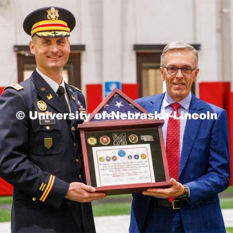 Chancellor Ronnie Green accepts a shadowbox from Lieutenant Colonel Mark Peer. ROTC Joint Service Chancellor’s Review in Cook Pavilion. April 27, 2023. Photo by Craig Chandler / University Communication.