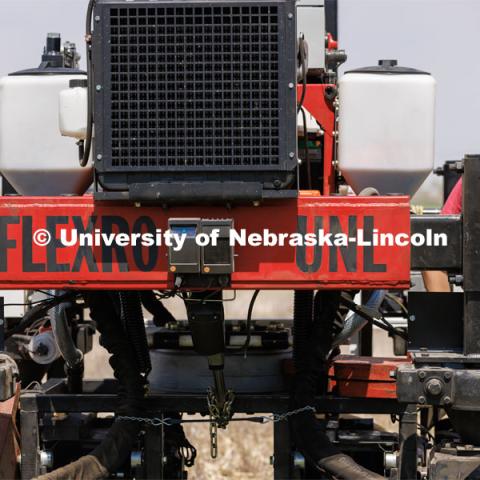 Flex-Ro, which first entered fields in 2019 to measure crop traits, can be controlled remotely and operated autonomously. It has been designed to be modular and reconfigurable, with different modes of steering ability available on the fly. Flex-Ro is a robotic planter based on Santosh Pitla’s tractor platform works its way through a field at the Rogers Memorial Farm east of Lincoln. April 27, 2023. Photo by Craig Chandler / University Communication.