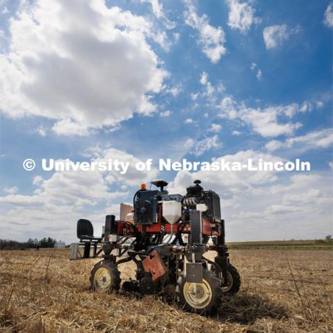 Flex-Ro, which first entered fields in 2019 to measure crop traits, can be controlled remotely and operated autonomously. It has been designed to be modular and reconfigurable, with different modes of steering ability available on the fly. Flex-Ro is a robotic planter based on Santosh Pitla’s tractor platform works its way through a field at the Rogers Memorial Farm east of Lincoln. April 27, 2023. Photo by Craig Chandler / University Communication.