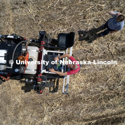 Graduate student Ian Tempelmeyer checks the programming on the planter as it turns for another row. The self-driving robotic planter based on Santosh Pitla’s tractor platform works its way through a field at the Rogers Memorial Farm east of Lincoln. April 27, 2023. Photo by Craig Chandler / University Communication.