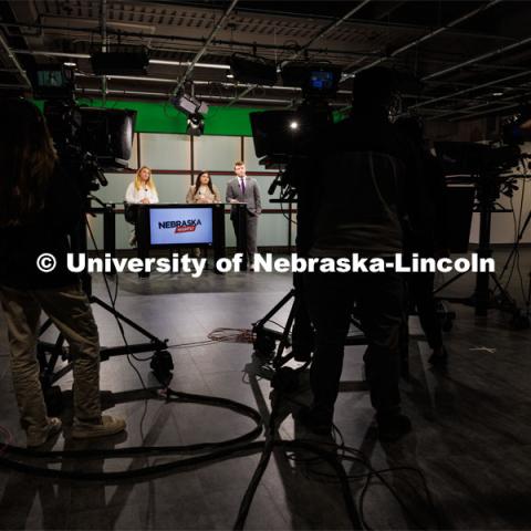 The on-air talent watch as a final segment airs on the broadcast. Students produce their Nebraska Nightly telecast in the new Don and Lorena Meier Studio. April 28, 2023. Photo by Craig Chandler / University Communication.