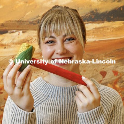 Emma Schlenker, a second-year law student, holds the corncob gavel she carved from an Eastern Cottonwood, the Nebraska state tree. College of Law photo shoot. April 28, 2023. Photo by Craig Chandler / University Communication.