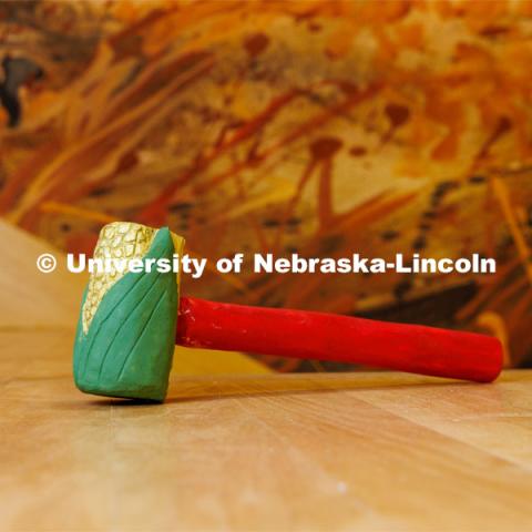 Corn gavel designed and carved by Emma Schlenker, a second-year law student. The gavel is carved from Eastern Cottonwood, the Nebraska state tree. College of Law photo shoot. April 28, 2023. Photo by Craig Chandler / University Communication.
