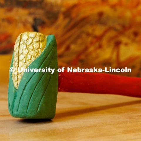 Corn gavel designed and carved by Emma Schlenker, a second-year law student. The gavel is carved from Eastern Cottonwood, the Nebraska state tree. College of Law photo shoot. April 28, 2023. Photo by Craig Chandler / University Communication.