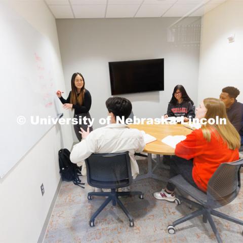 Students use a marker board while studying in a study room. College of Law photo shoot. April 28, 2023. Photo by Craig Chandler / University Communication.