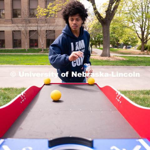 Freshman Microbiology major Jesus Worth plays ski-ball at the 2023 End of Year Bash at East Campus Mall. April 29, 2023. Photo by Jordan Opp for University Communication.