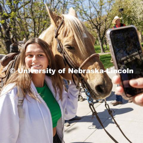 Bella Rodriguez, a sophomore from Kansas City, Missouri, poses for a photo at the event. Students in Rob Simon’s capstone marketing course held a promotional event for the UNL rodeo on the west side of the Union on City Campus. The class developed a marketing strategy for the Rodeo Club to help promote their upcoming rodeo. Seven horses and multiple club members were on city campus for students to meet, get close to and have their photos taken. May 1, 2023. Photo by Craig Chandler / University Communication.