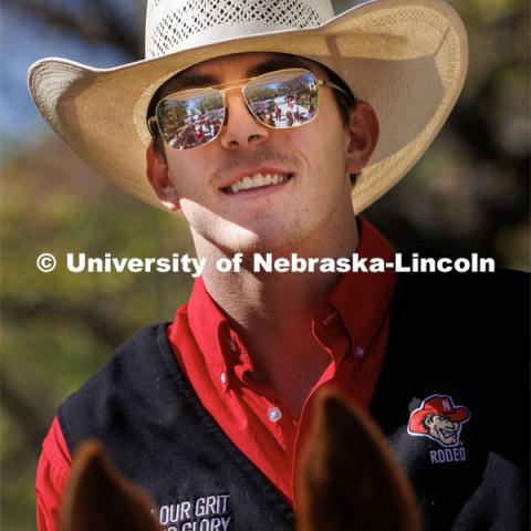The horses and students are reflected in the sunglasses of Rodeo Club member Josiah Kamler. Students in Rob Simon’s capstone marketing course held a promotional event for the UNL rodeo on the west side of the Union on City Campus. The class developed a marketing strategy for the Rodeo Club to help promote their upcoming rodeo. Seven horses and multiple club members were on city campus for students to meet, get close to and have their photos taken. May 1, 2023. Photo by Craig Chandler / University Communication.