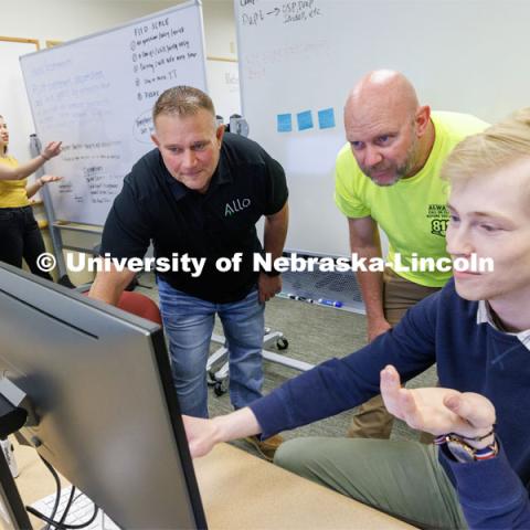 Erik Konnath, right, talks with members of the Allo team, Ed Jarrett and Jon McHenry (in yellow t-shirt) as they discuss the project. In the background from left are Design Studio team members Sophie Hill and Hannah Pokharel. May 2, 2023. Photo by Craig Chandler / University Communication.