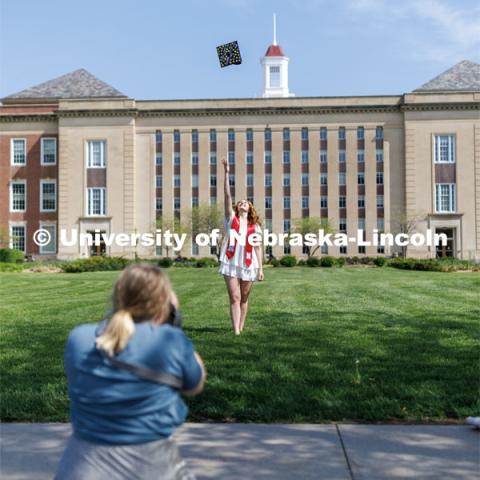 Tessa Sutfin, an elementary education and early childhood education major, has her graduation photo taken outside Love Library Wednesday morning. Sutfin, who will begin her career as kindergarten teacher in the Millard School District, throws her cap for a graduation photo outside Love Library. May 10, 2023. Photo by Craig Chandler / University Communication.