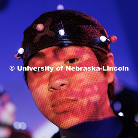 Students work in the Johnny Carson EMA MoCap (motion capture) lab wearing MoCap suits. The suits with their infrared sensors (round dots velcroed to the suit) allow a ring of cameras to turn their motion into animated characters on screen. May 17, 2023. Photo by Craig Chandler / University Communication.