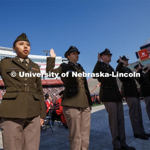 ROTC students in the Army, Air Force and Navy ROTC programs at UNL including now Second Lieutenant Jenifer Valazquez-Perfecto, left, take their oath of office at the beginning of the ceremony. Undergraduate commencement at Memorial Stadium. May 20, 2023. Photo by Craig Chandler / University Communication.