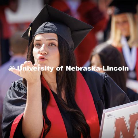 Lauryn Johnson blows a kiss to the video cameras recording the graduates for the live broadcast of the ceremony. Undergraduate commencement at Memorial Stadium. May 20, 2023. Photo by Craig Chandler / University Communication.