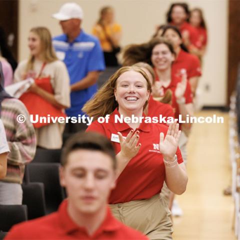 Delaney Wetjen runs to the stage with the other orientation leaders to start the day’s program. New Student Enrollment. May 30, 2023. Photo by Craig Chandler / University Communication.