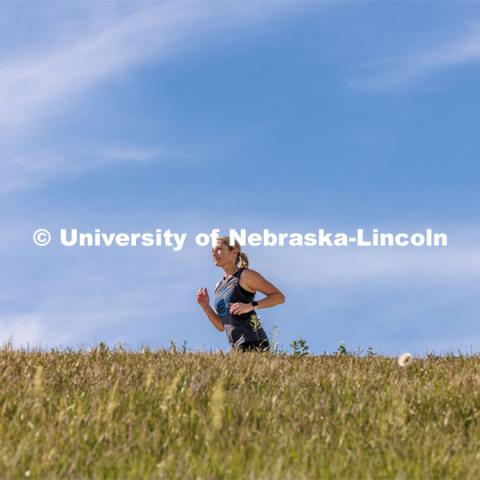 Dean Shari Veil trains along the paths at Holmes Lake. She runs marathons. College of Journalism and Mass Communication. Downtime with the Deans series for Alumni Magazine. May 30, 2023. Photo by Craig Chandler / University Communication.