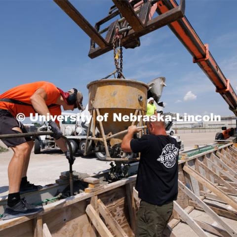 Concrete is poured into a barrier being tested at the Midwest Roadside Safety Facility for the State of Hawaii. June 5, 2023. Photo by Craig Chandler / University Communication.
