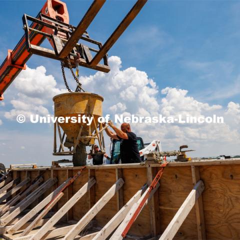 Concrete is poured into a barrier being tested at the Midwest Roadside Safety Facility for the State of Hawaii. June 5, 2023. Photo by Craig Chandler / University Communication.
