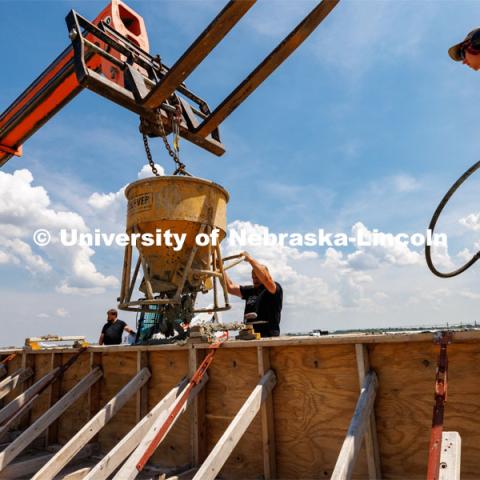 Concrete is poured into a barrier being tested at the Midwest Roadside Safety Facility for the State of Hawaii. June 5, 2023. Photo by Craig Chandler / University Communication.
