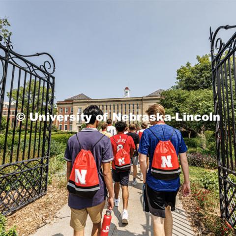 The campus tour takes the group through the gates of the Love Gardens. New Student Enrollment ( NSE ) on City Campus. June 13, 2023. Photo by Craig Chandler / University Communication.