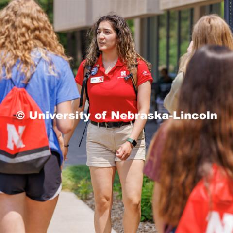Orientation Leader Crystal Carrillo leads her group across campus. New Student Enrollment ( NSE ) on City Campus. June 13, 2023. Photo by Craig Chandler / University Communication.