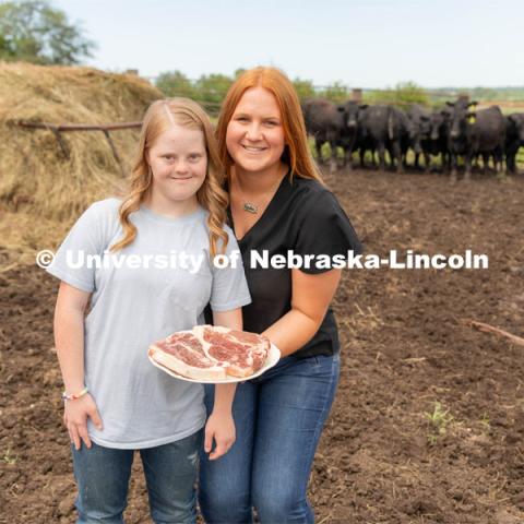 Allison Walbrecht, a freshman majoring in Animal Science, poses with Claire Bruns in a promotion photo for United Agriculture. Unified Agriculture is a beef direct to consumer dedicated to creating employment opportunities within agriculture for those disabilities. Walbrecht also created the 4-H Unified Showing Club by which a youth with a disability is paired with a buddy who helps them prepare for a lamb showing at a county fair. July 3, 2023. Credit photo by Hannah Dorn.