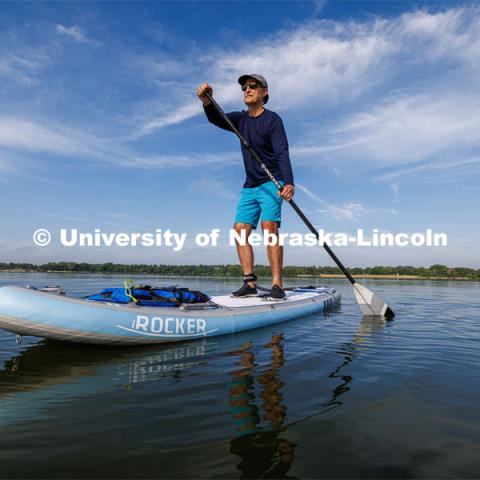 Richard Moberly, dean of the college of law, paddleboards at Pawnee State Recreation area northwest of Lincoln. Downtime with the Deans series for Alumni Magazine. July 19, 2023. Photo by Craig Chandler / University Communication.