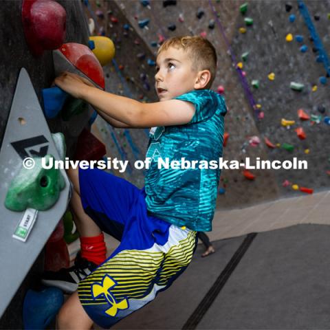 One camper climbs on the rock wall at the Outdoor Adventures Center. Husker Kids Camp. July 25, 2023.  Photo by Craig Chandler / University Communication.