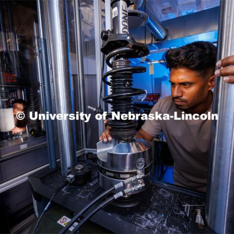 Gnyarienn Selva Kumar works on setting up a strut for a compression test while Doreen Rahman does the same for a concrete sample. Both are masters students in mechanical engineering. They work in Cody Stolle’s lab in Whittier. July 27, 2023. Photo by Craig Chandler / University Communication.