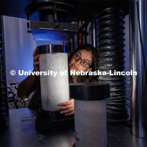 Doreen Rahman sets up a compression test for a concrete sample. She is a masters student in mechanical engineering and works in Cody Stolle’s lab in Whittier. July 27, 2023. Photo by Craig Chandler / University Communication.