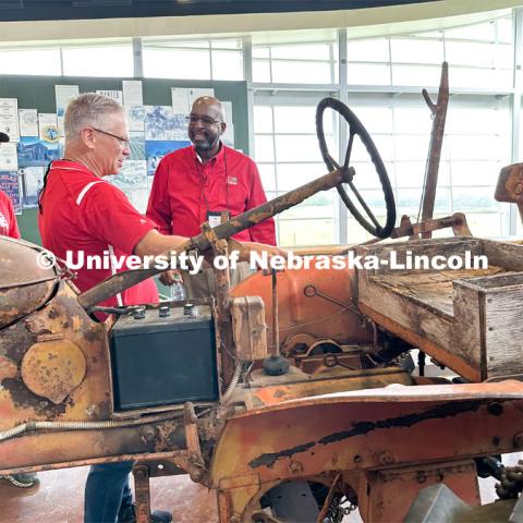 Rodney Bennett looks over a preserved tractor from the Alaskan land of the last homesteader. The tractor was preserved at the UNL Tractor Museum before it was put on display at the Homestead National Historic Park near Beatrice. IANR Roads Scholar Tour through Nebraska. August 1, 2023. Photo by Craig Chandler / University Communication.