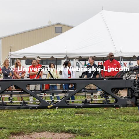 Chancellor Rodney Bennett and the road tour listens as Quentin Cooksley, Director of Commercial and Application Business at AKRS Equipment and UNL alumni, describes a John Deere sprayer that uses cameras and computers to only spray the weeds. The sprayer was being demonstrated at the South Central Ag Lab field day for area farmers. IANR Roads Scholar Tour through Nebraska. August 1, 2023. Photo by Craig Chandler / University Communication.